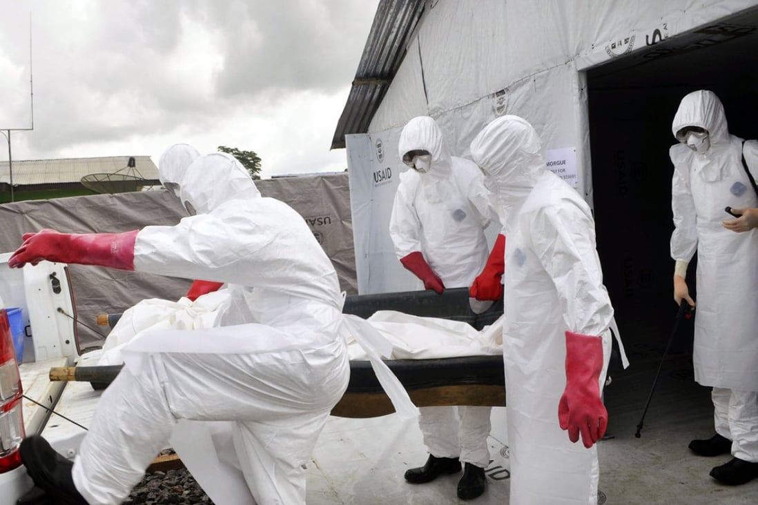 Body of a suspected Ebola victim is moved in Liberia. Photo: AP