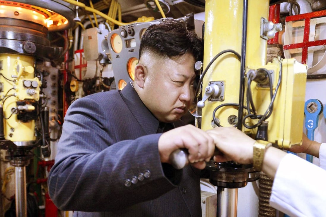 North Korean leader Kim Jong-un peers through a periscope of a submarine during an inspection of the Korean People's Army Navan Unit in June. Photo: Reuters