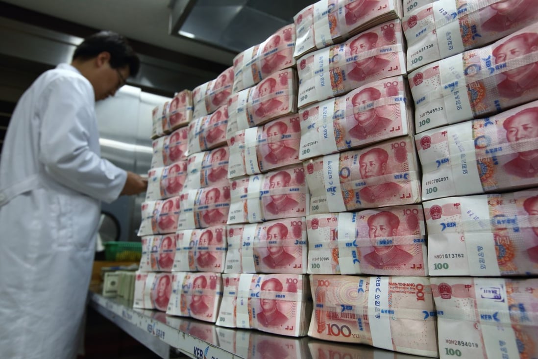 Stacks of Chinese yuan notes are seen as the implied guarantee of the People's Bank of China is said to be intact as Beijing seeks to maintain social calm. Photo: Bloomberg