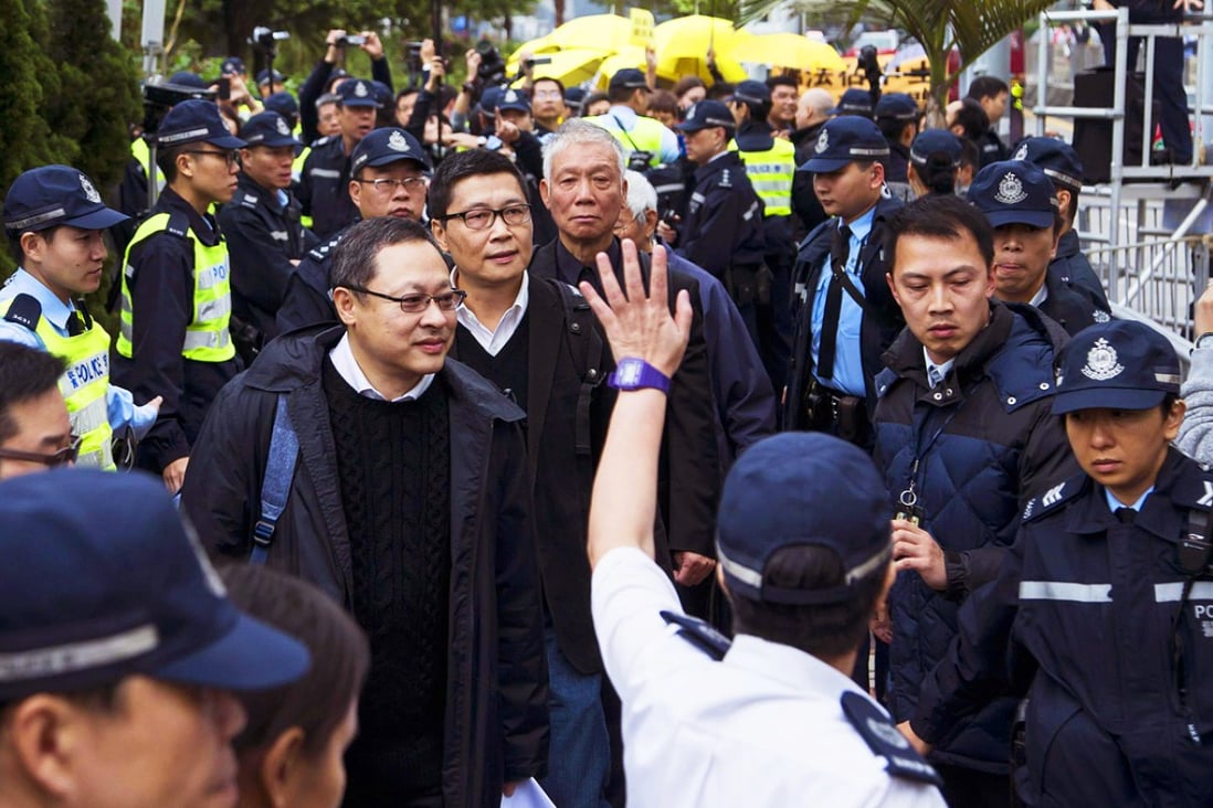 The Occupy Central trio of Benny Tai, Dr Chan Kin-man and the Reverend Chu Yiu-ming walk to Central Police Station yesterday. Photo: Reuters