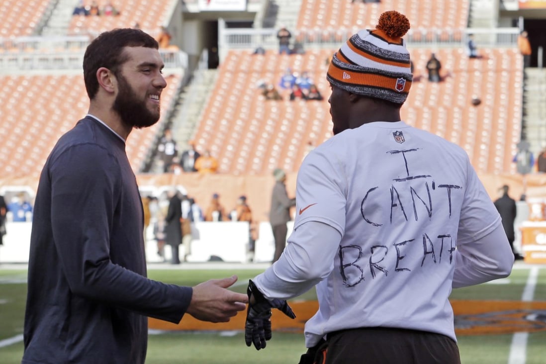 Indianapolis Colts quarterback Andrew Luck, left, talks with Cleveland Browns cornerback Johnson Bademosi. Photo: AP
