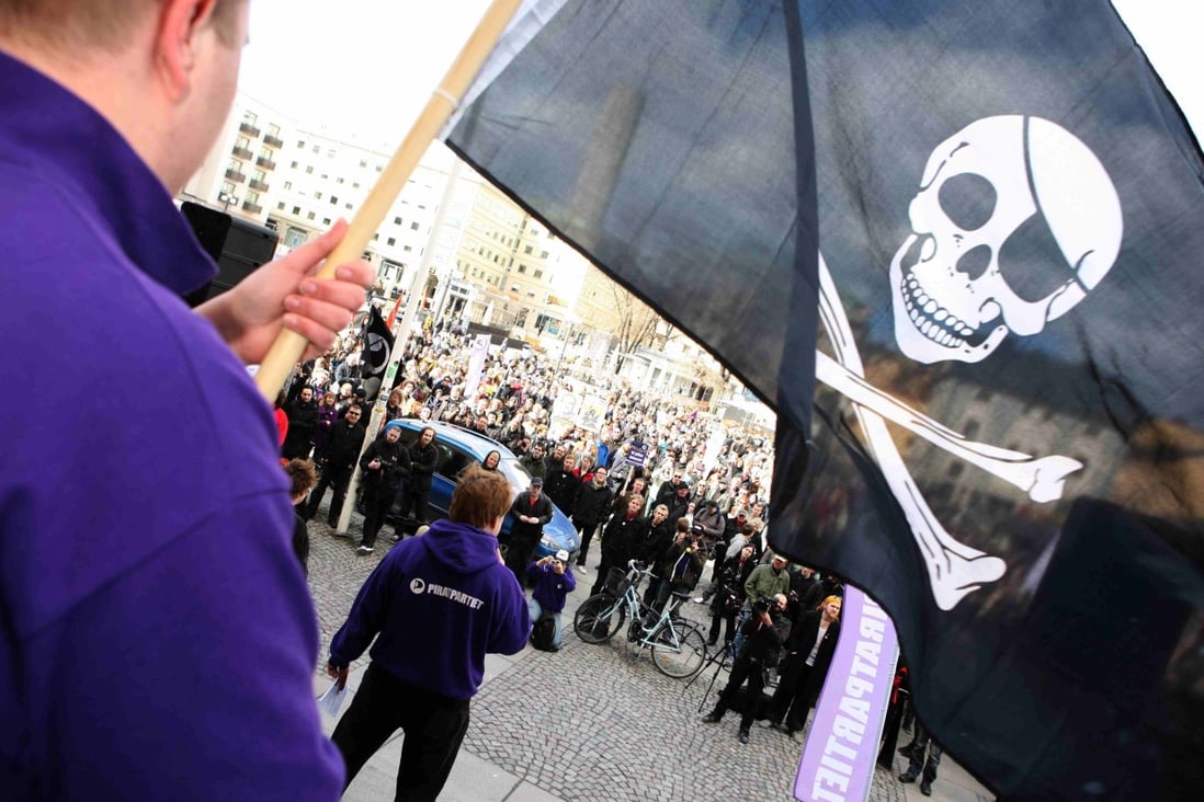 A supporter of file-sharing hub The Pirate Bay, waves a Jolly Roger flag during a demonstration in Stockholm in 2009. Photo: Reuters