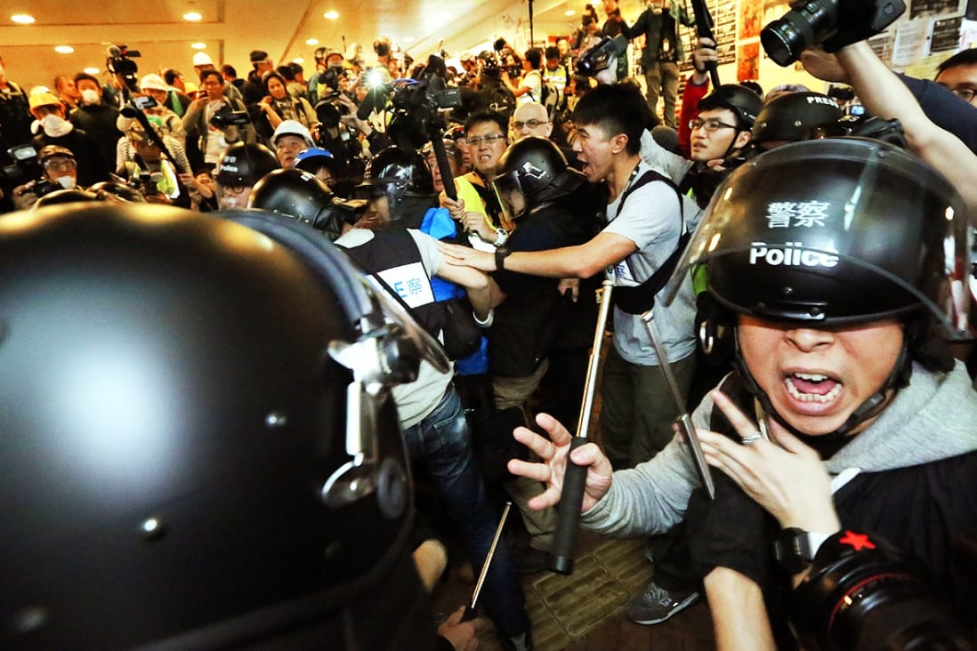 Police officers clash with pro-democracy protesters outside Central Government Offices in Admiralty. Photo: Felix Wong