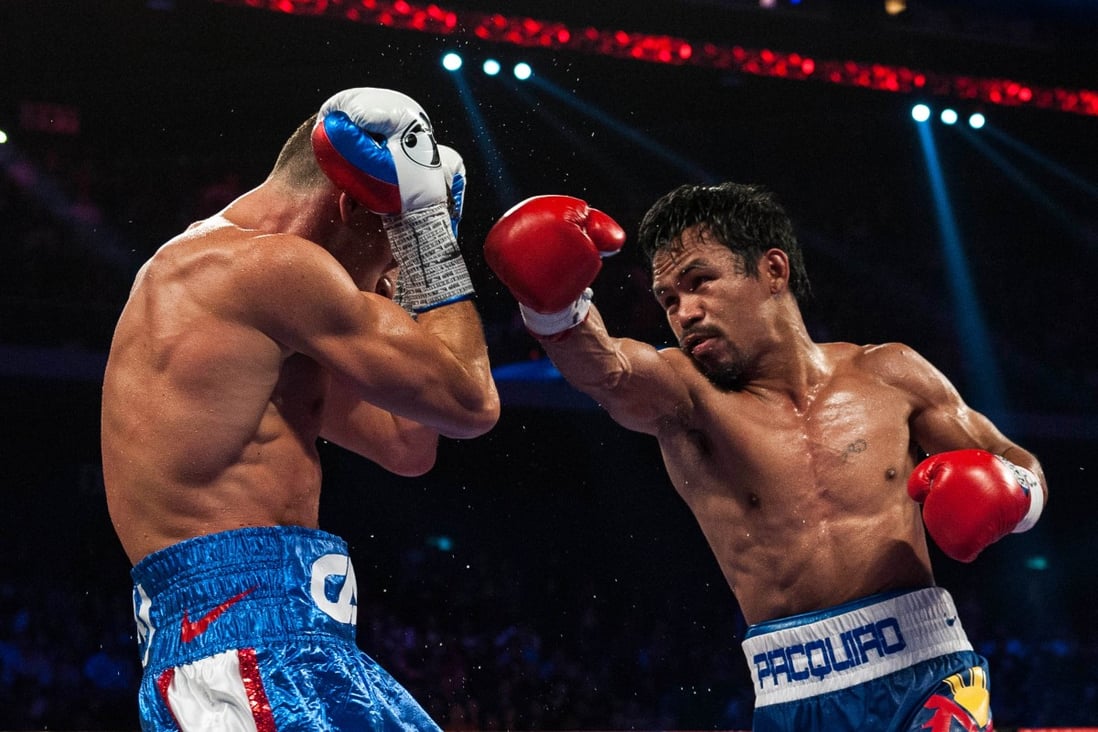 Manny Pacquiao takes apart previously unbeaten Chris Algieri in their World Boxing Organisation welterweight title bout in Macau on November 23. Photo: AFP