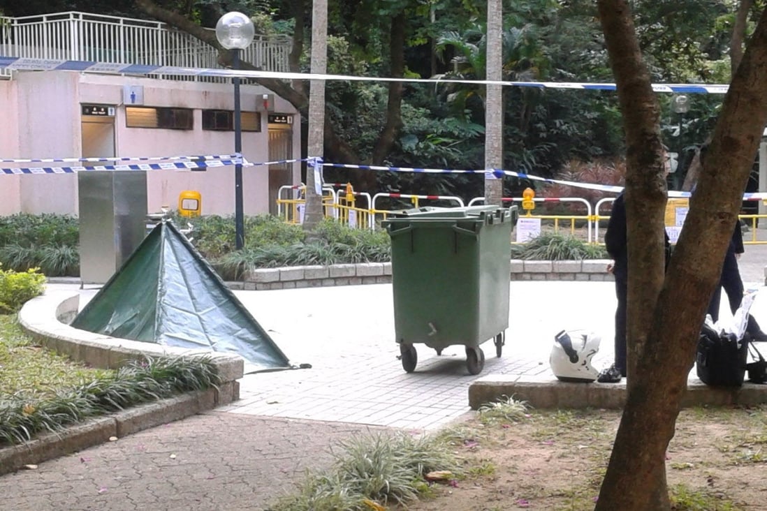A green tent covers a woman's dead body. Photo: SCMP 