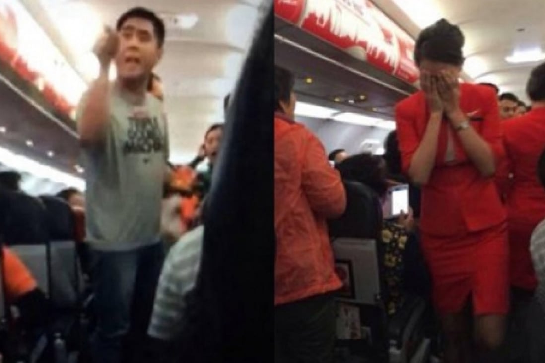 A man (left) seen apparently threatening air hostesses on the Thai AirAsia flight. Photo: SCMP Pictures