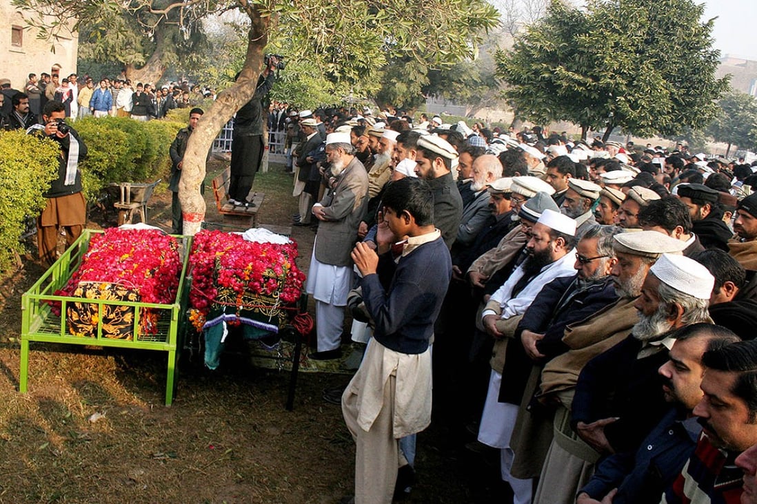 Mourners attend a funeral ceremony of two victims of the Taliban's attack on an army-run school in Peshawar. Photo: Xinhua