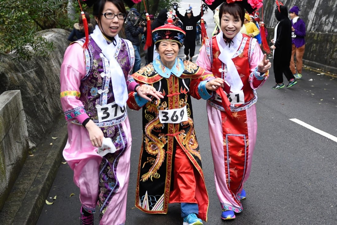 Runners dressed in traditional Chinese attire compete in Friday's run at Wan Chai Gap. Photo: Richard Castka