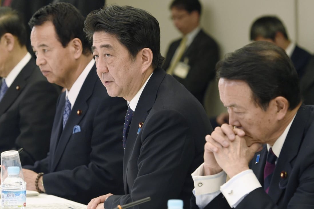 Shinzo Abe approving the stimulus plan yesterday. Photo: Kyodo