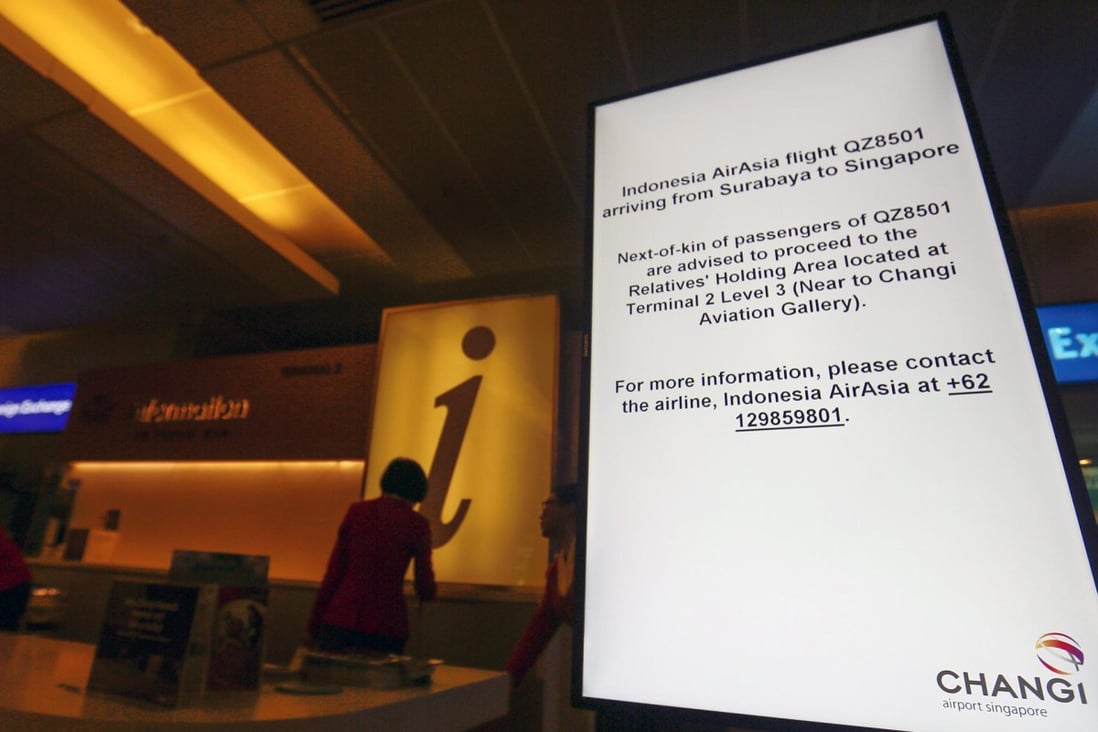 A sign directs relatives of passengers on the missing AirAsia flight to a holding area at the Changi Airport in Singapore. Photo: EPA