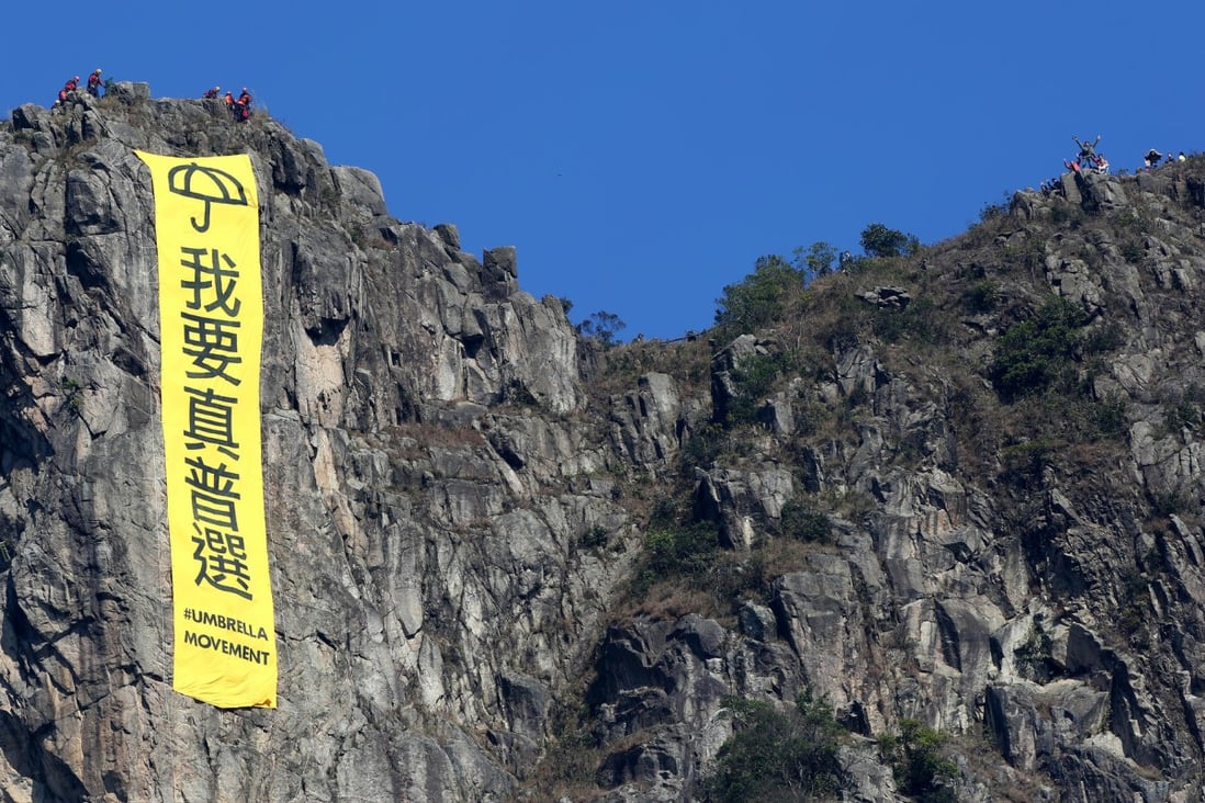 Another yellow banner is unfurled atop the famous Lion Rock. Like the one hoisted there in October, it carries the slogan 'I want genuine universal suffrage'. Photo: Nora Tam