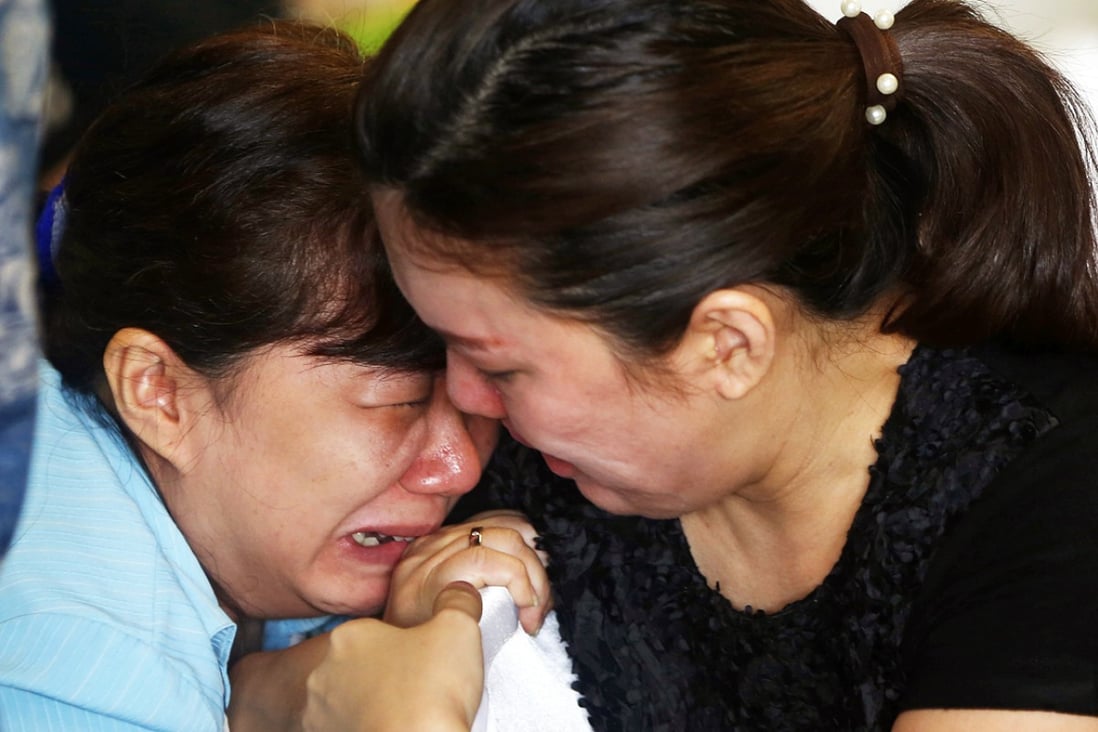 Bracing for the worst, a relative of a QZ 8501 passenger weeps at the Surabaya airport as the second day of search operations for the missing jet yields little answers. Photo: Reuters