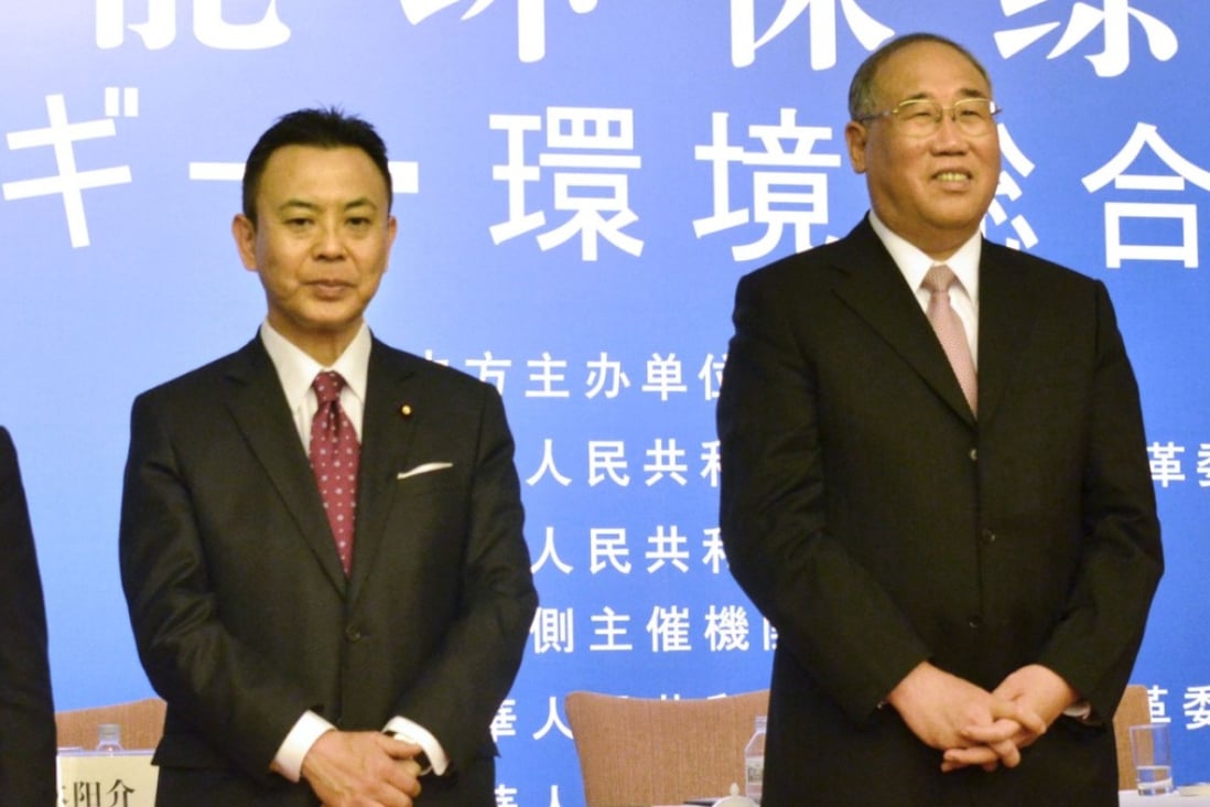 Japan's Yosuke Takagi (left) and China's Xie Zhenhua at the eighth Japan-China Energy Conservation Forum in Beijing. Photo: Kyodo