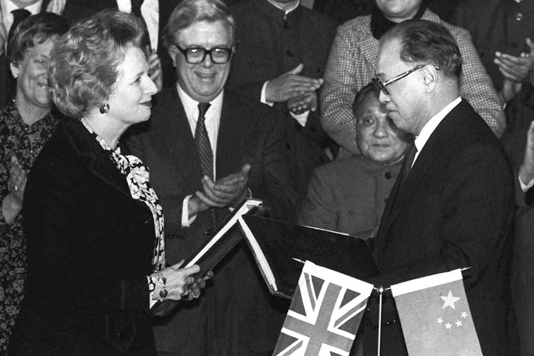 Margaret Thatcher and then premier Zhao Ziyang exchange signed copies of the Hong Kong handover agreement in Beijing in December 1984. Photo: AP
