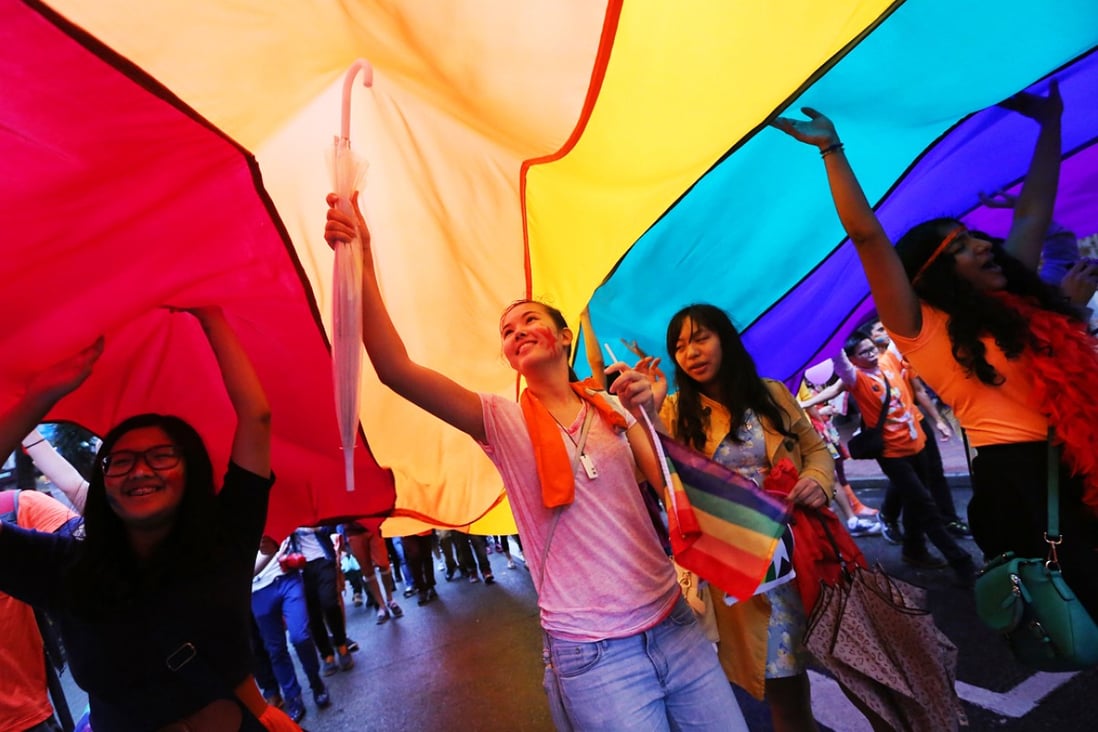Participants hold giant rainbow flags during Hong Kong Pride Parade in Causeway Bay. Photo: Sam Tsang