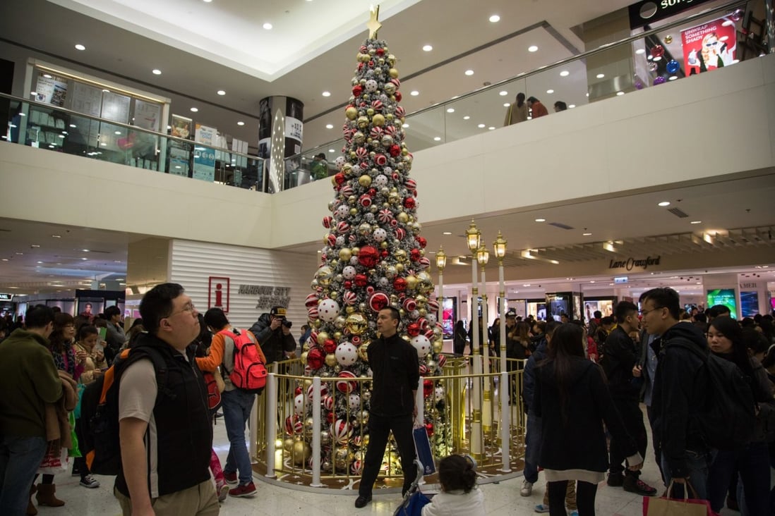 Christmas shoppers in Hong Kong stroll inside Harbour city shopping mall operated by Wharf Holdings, which is due to launch the first luxury property project in the city this year on Mount Nicholson Road. Photo: Bloomberg