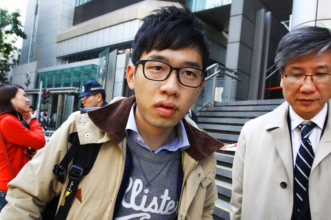 Hong Kong Federation of Students' committee member Nathan Law Kwun-chung (left) arrives at police headquarters. Photo: Dickson Lee