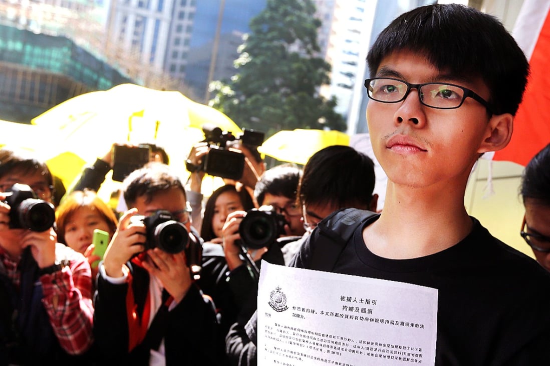 Joshua Wong arrives at Wan Chai police station on Friday morning. Photo: Sam Tsang