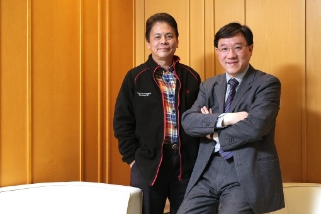 Director of PolyU DBA Programme Professor Wilson Tong Hin-sang (L), and its alumni Danny Po Chun-wong