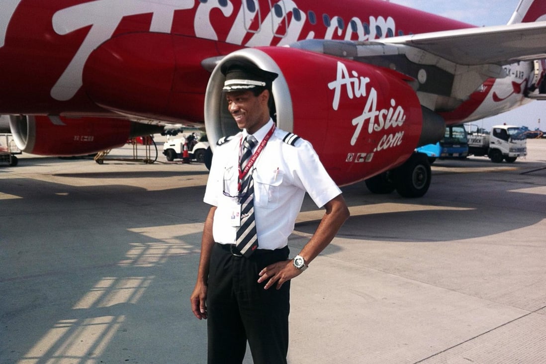 Co-pilot Remi Plesel in front of an AirAsia plane. Photo: AFP