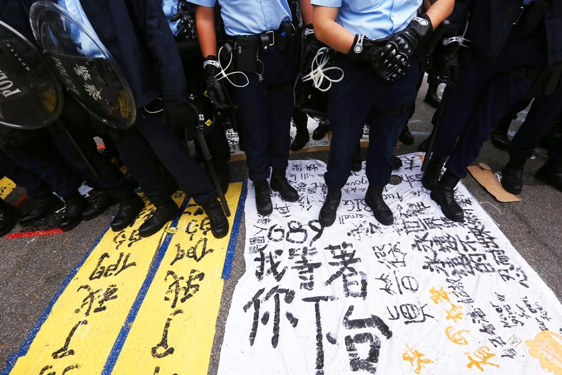 Police stand guard at at protest site in Admiralty during police removed barricades and tore down tents. Photo: Felix Wong