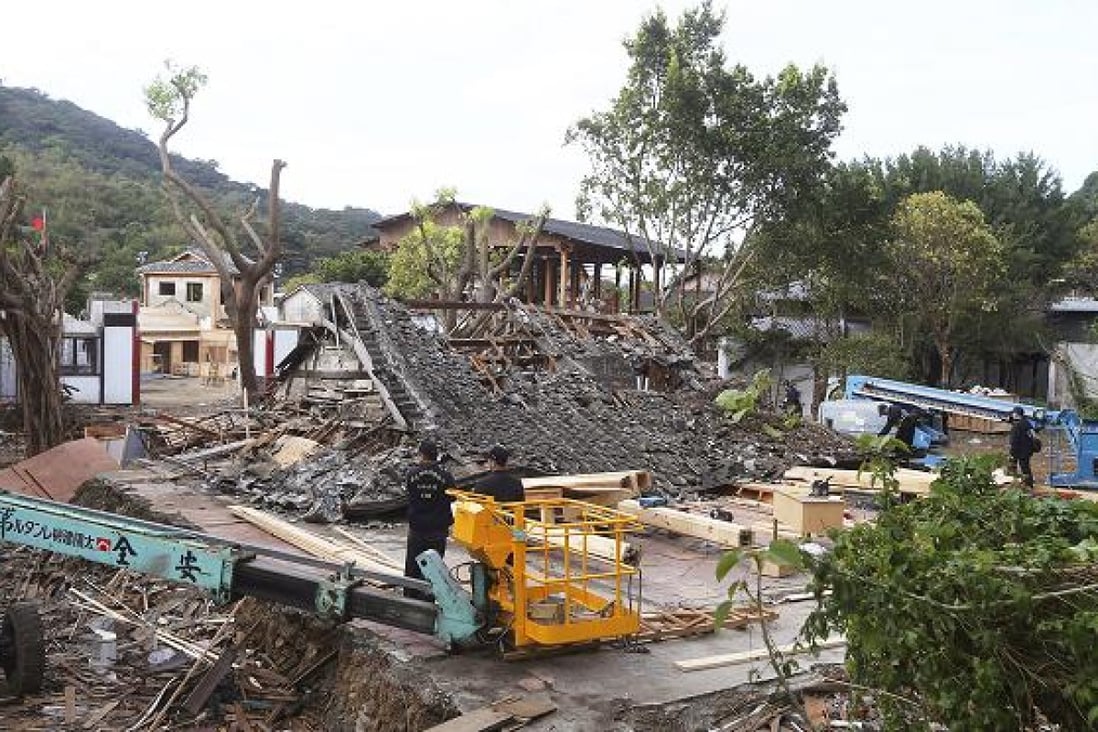 Police inspect the demolished film set after a construction worker was killed when scaffolding around a building being demolished suddenly collapsed. Photo: AP 