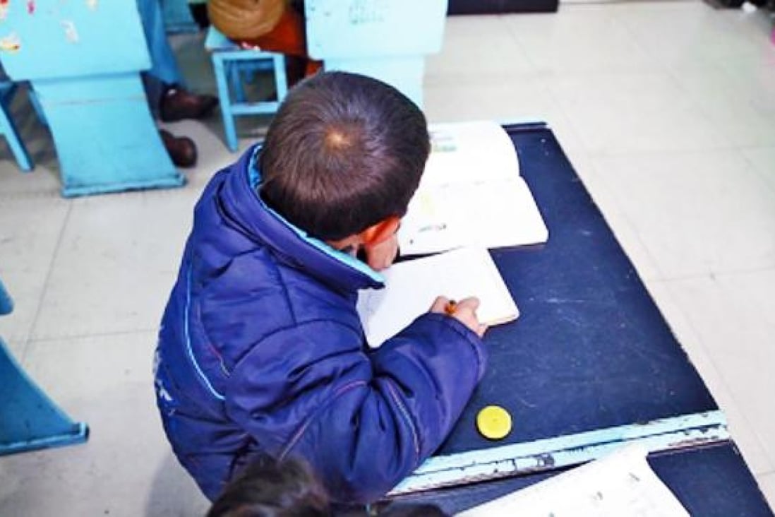 An eight-year-old boy has been living at a primary school in Henan after he was abandoned by his father in August. Photo: SCMP Pictures