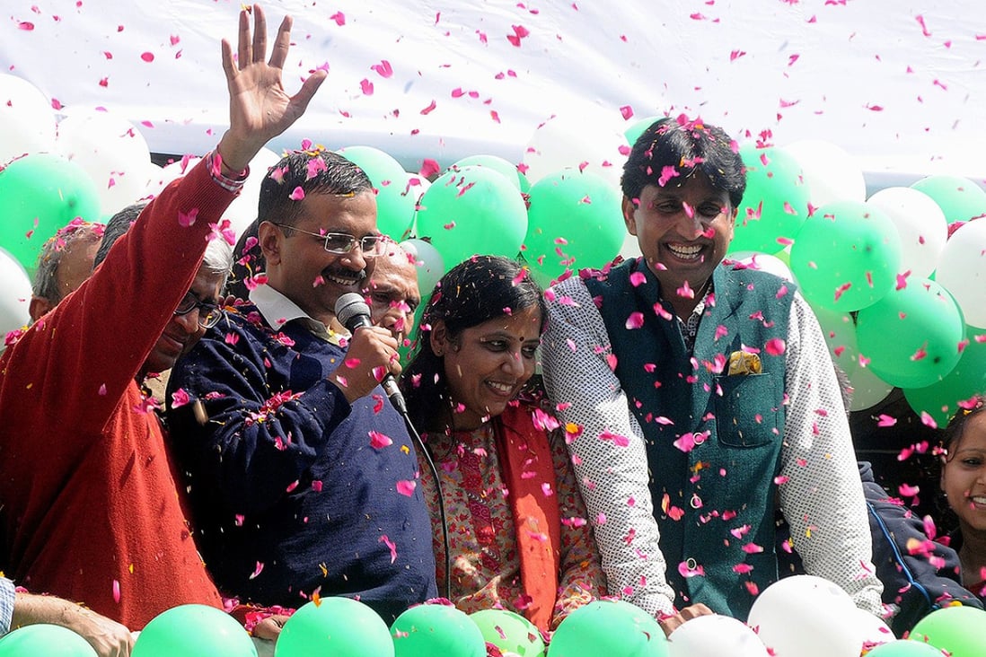 Aam Aadmi Party leader Arvind Kejriwal (centre) addresses his supporters with party leaders Kumar Vishwas (right) and Ashuthosh outside their party office in New Delhi. Photo: EPA