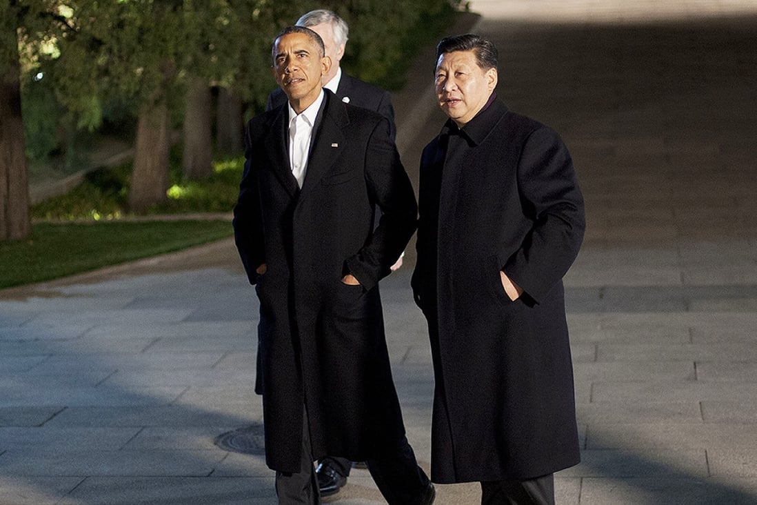 Xi and Obama walk together at the Zhongnanhai leaders compound in Beijing before a private dinner in November. Photo: AP 