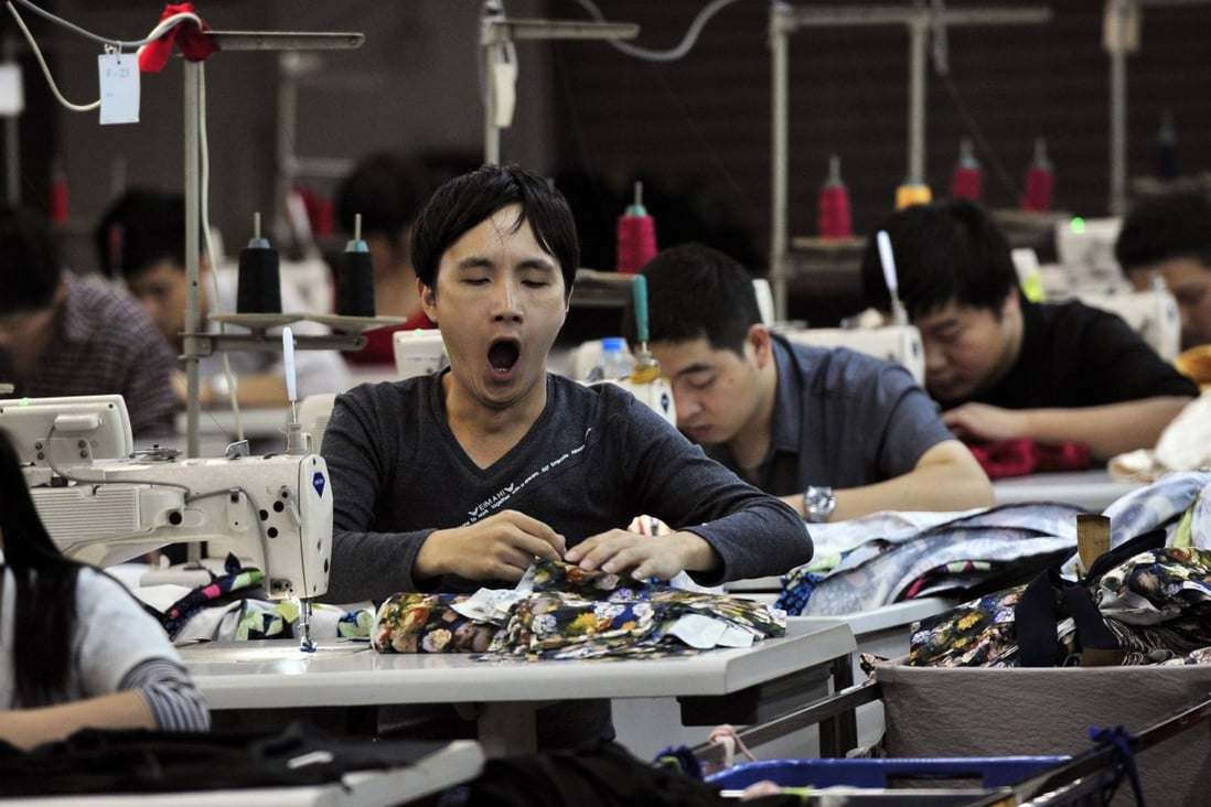 An employee yawns at a garment factory in Humen township, Guangdong province. Photo: Reuters