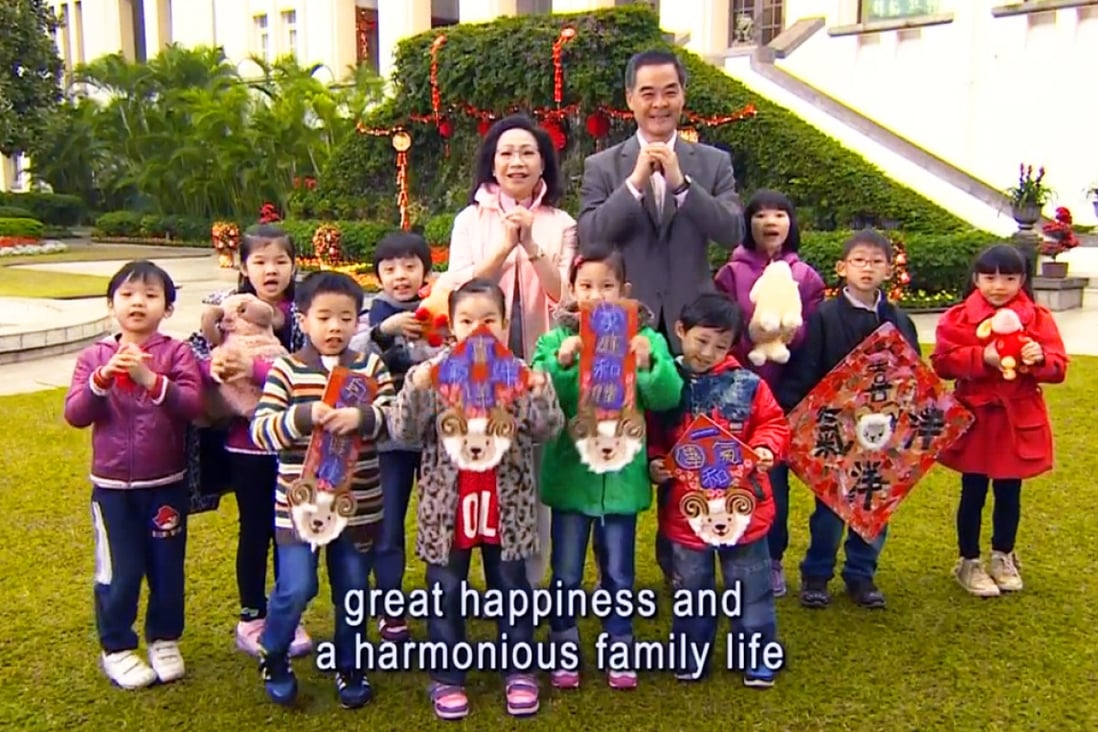 CY Leung and his wife pose with children in the Year of the Sheep greeting. Photo: Hong Kong Government