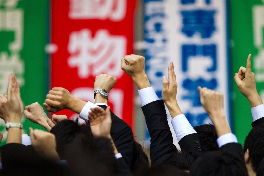 Japanese college graduates attend a rally intended for job seekers. After nearly two decades of recession, Japan's economy is growing again. Photo: Reuters