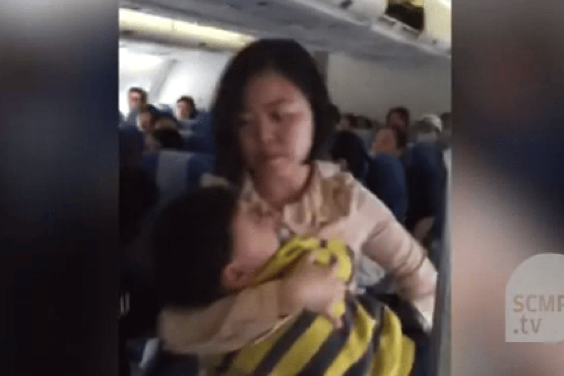 The mainland Chinese mother takes her child and leaves the cabin after a heated dispute with fellow passengers and crew. 