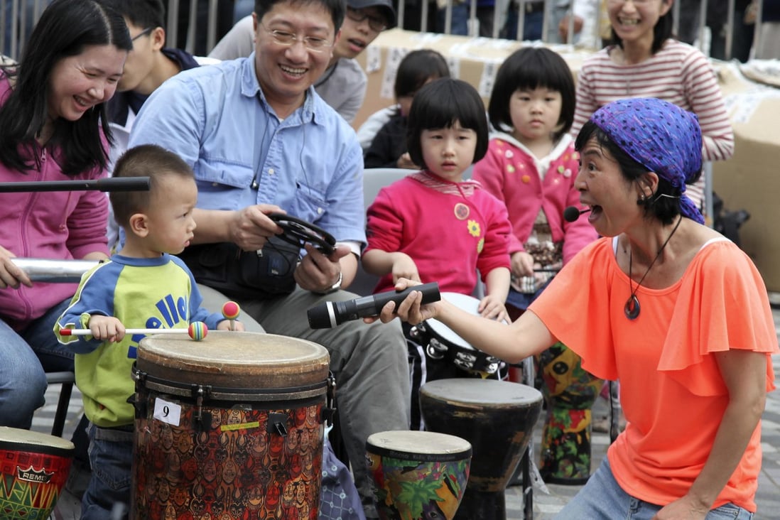 Kumi Masunaga introduces local families to the joys of Drum Jam. Photo: Danny Chan