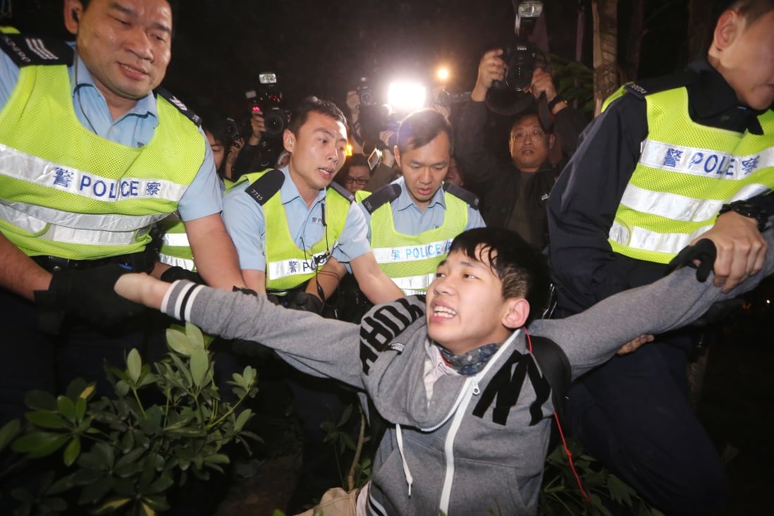 Police arrest a protester during a rally against parallel trading outside the Tuen Mun West Railway MTR station. Photo: Felix Wong