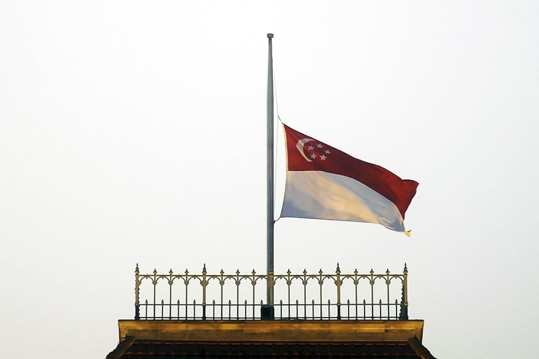 The Singapore flag flies at half-mast at Parliament House. Photo: Reuters