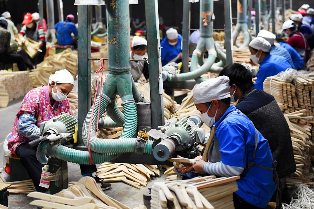 Workers making clothes hangers at a factory in the Guangxi region of southern China. The nation's economy recorded its lowest rate of growth in 24 years in 2014. Photo: Xinhua
