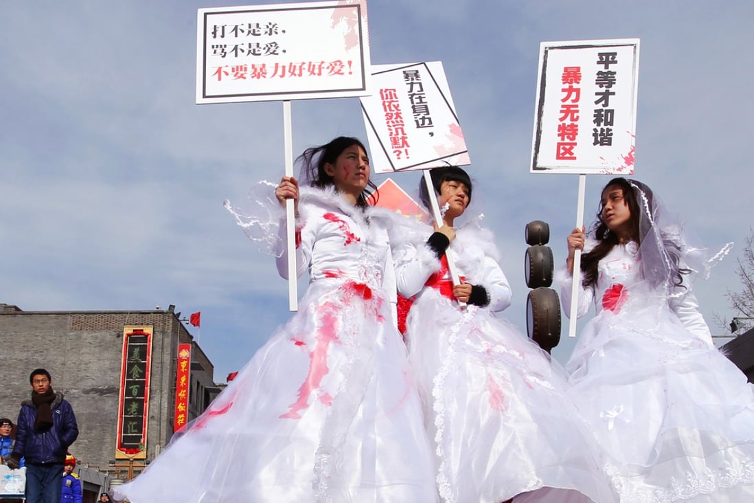 The activists paraded in red-splattered wedding gowns to highlight domestic violence. Photo: Simon Song