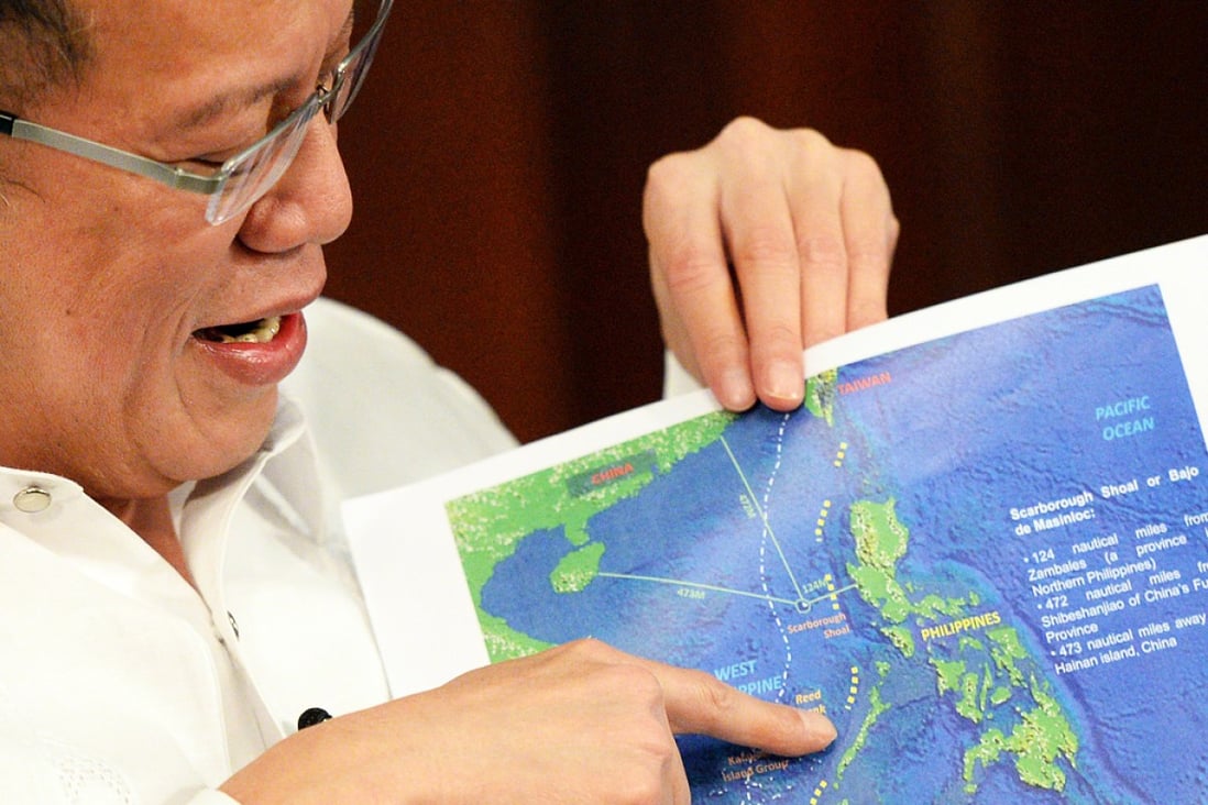 Philippine President Benigno Aquino shows a copy of China's nine-dash line map during an interview at Malacanang Palace in Manila. Photo: AFP