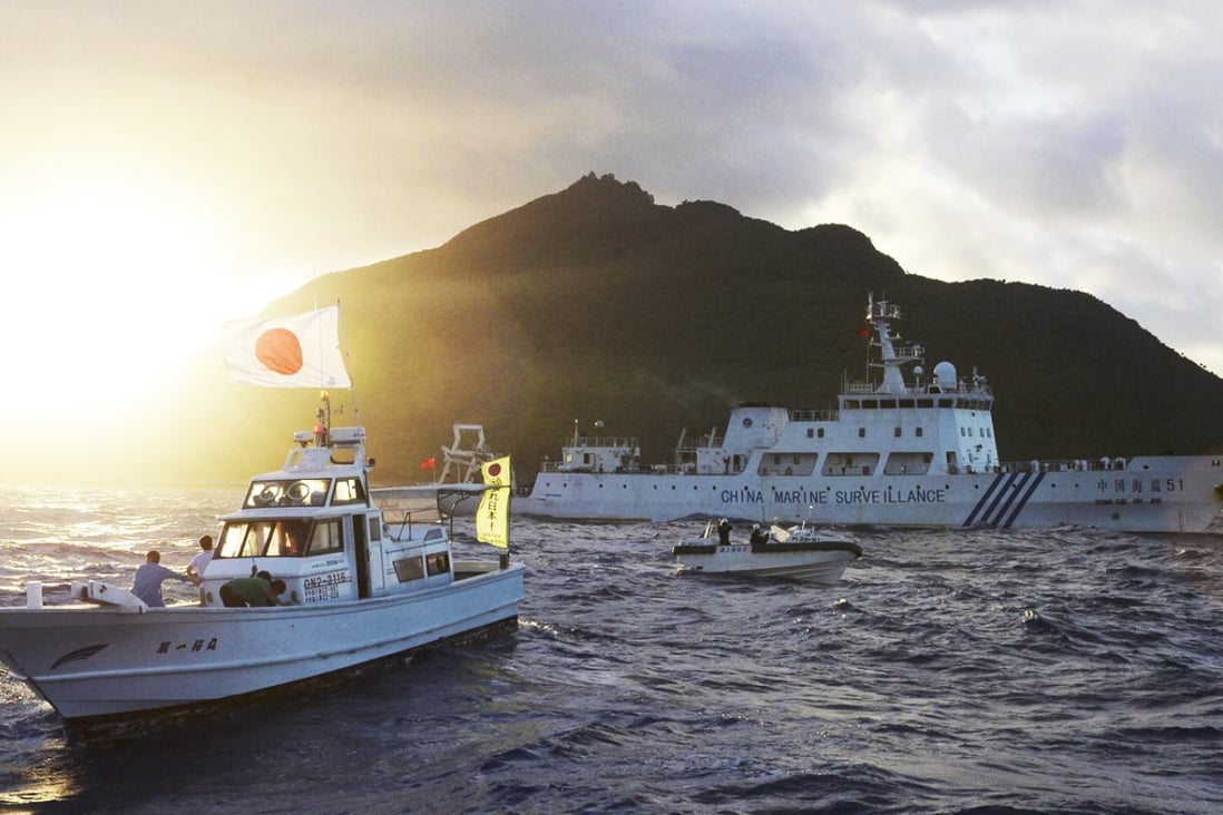 The large Chinese marine surveillance ship Haijian 51 sails through smaller Japanese coast guard vessels off disputed islands in the East China Sea in July, 2013. Photo: Kyodo/Reuters