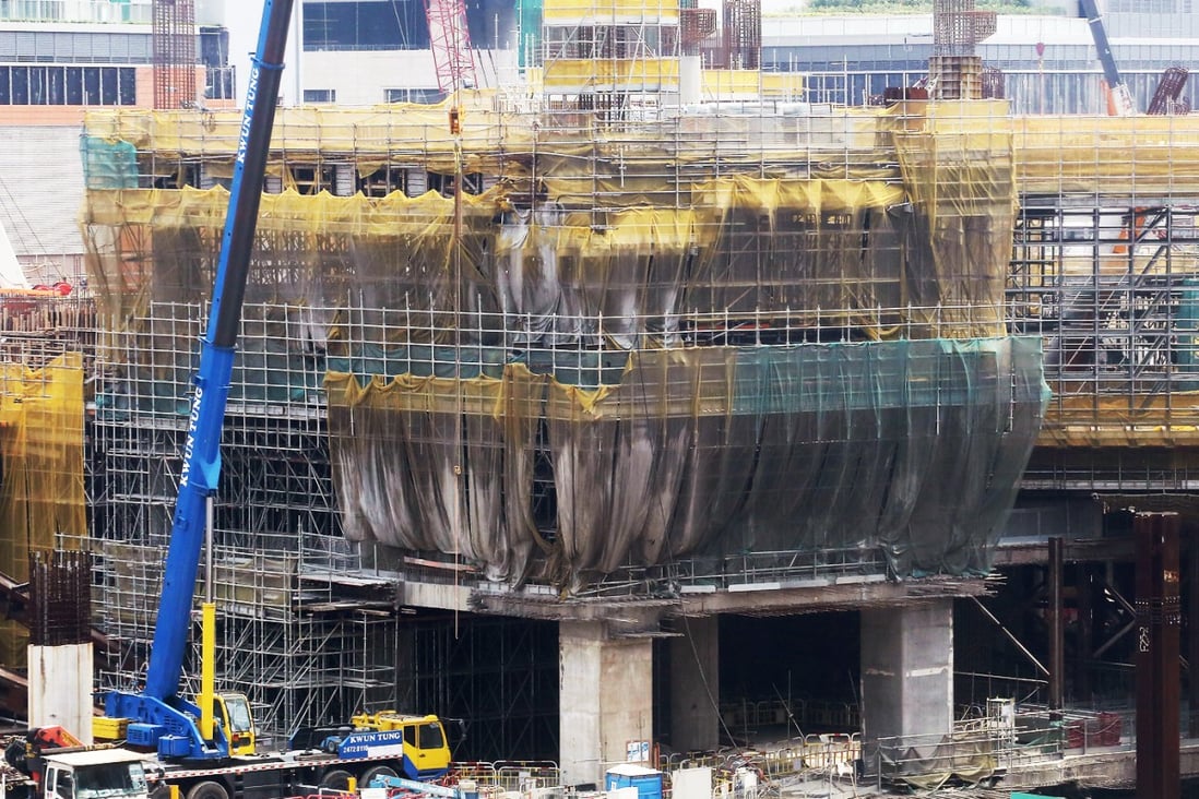Workers toil on the terminus in West Kowloon. Photo: Felix Wong