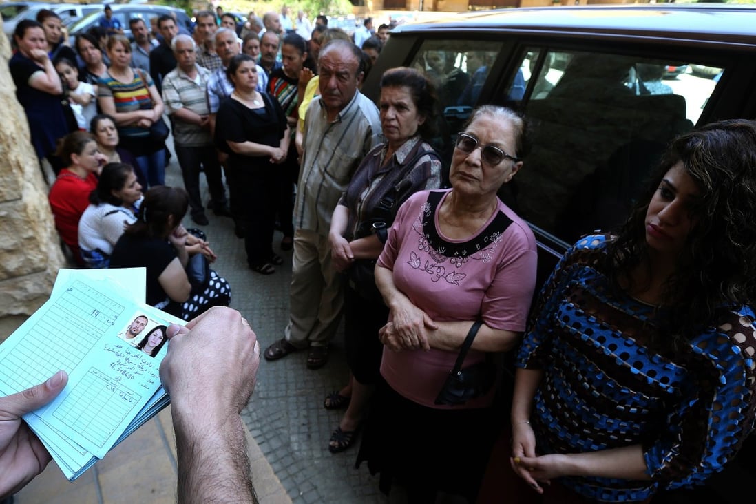 Iraqi Christians who fled the violence in Iraq between government forces and Islamic State militants wait to receive aid in Lebanon. Photo: AFP