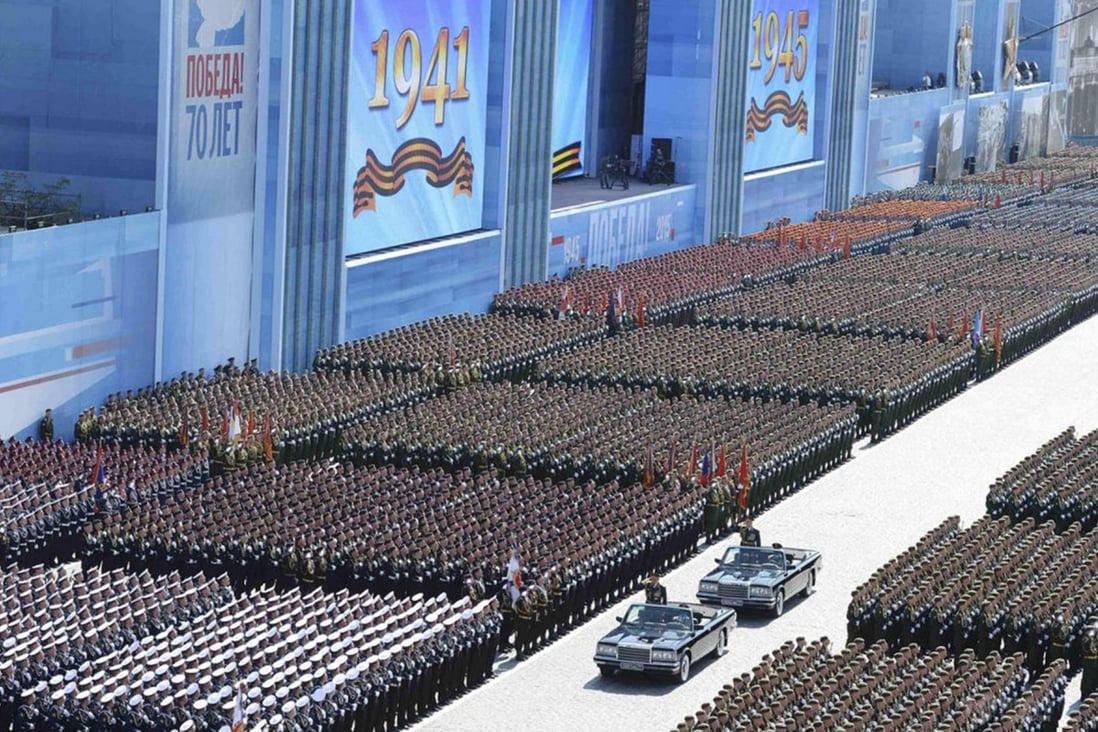 Russian defence minister Sergei Shoigu, in first car, and army commander Oleg Salyukov, behind, salute the victory parade in Red Square yesterday. Photo: SCMP