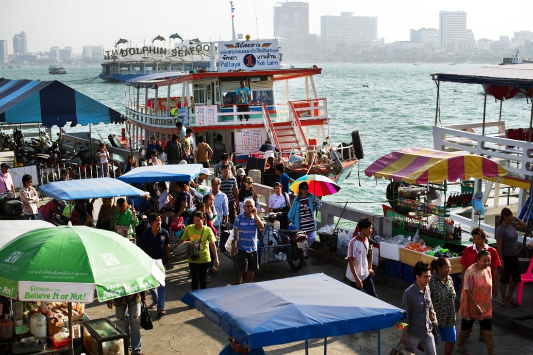 People disembark at the pier in Pattaya, Thailand, where thousands of Chinese employees from sales firm Infinitus will converge for a holiday paid for by the company. Photo: AFP