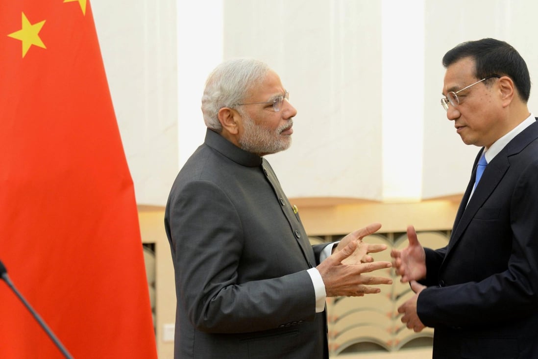 Chinese Premier Li Keqiang (right) chats with his Indian counterpart Narendra Modi after a joint press conference at Beijing's Great Hall of the People. Photo: Kyodo