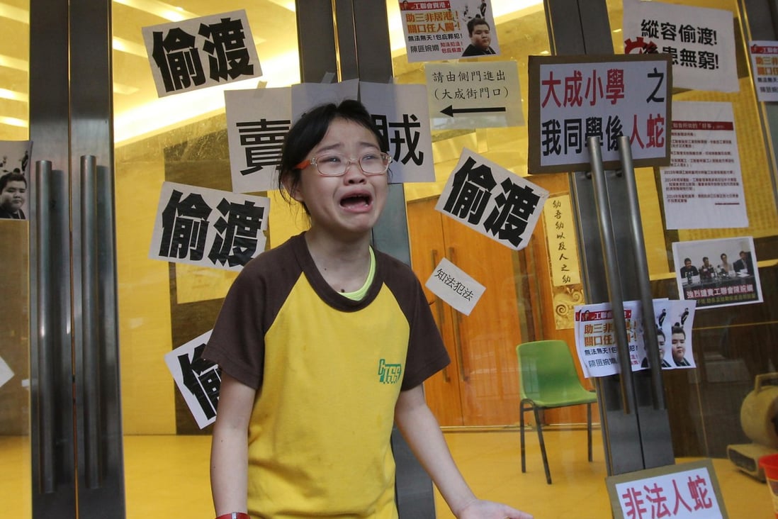 A pupil of the Confucian Tai Shing school cries after seeing the protest posters plastered on the school doors. Photo: Franke Tsang