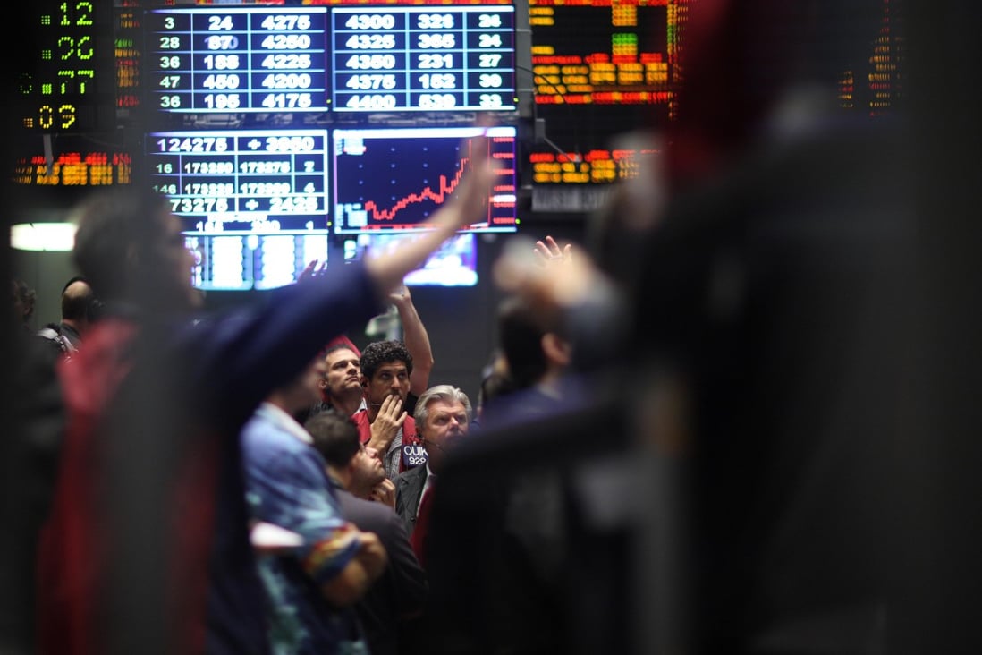 Traders signal orders in the Chicago Mercantile Exchange (CME), which is launching a challenge to the LME in the base metals market. Photo: Reuters