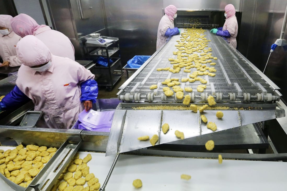 Employees work at a production line prior to inspections from the Shanghai Food and Drug Administration, at the Husi Food factory in Shanghai. Photo: Reuters