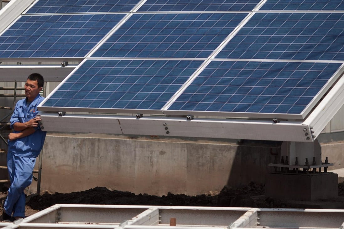 A worker takes a break from installing solar panels near the eco-city in Tianjin. Photo: AFP