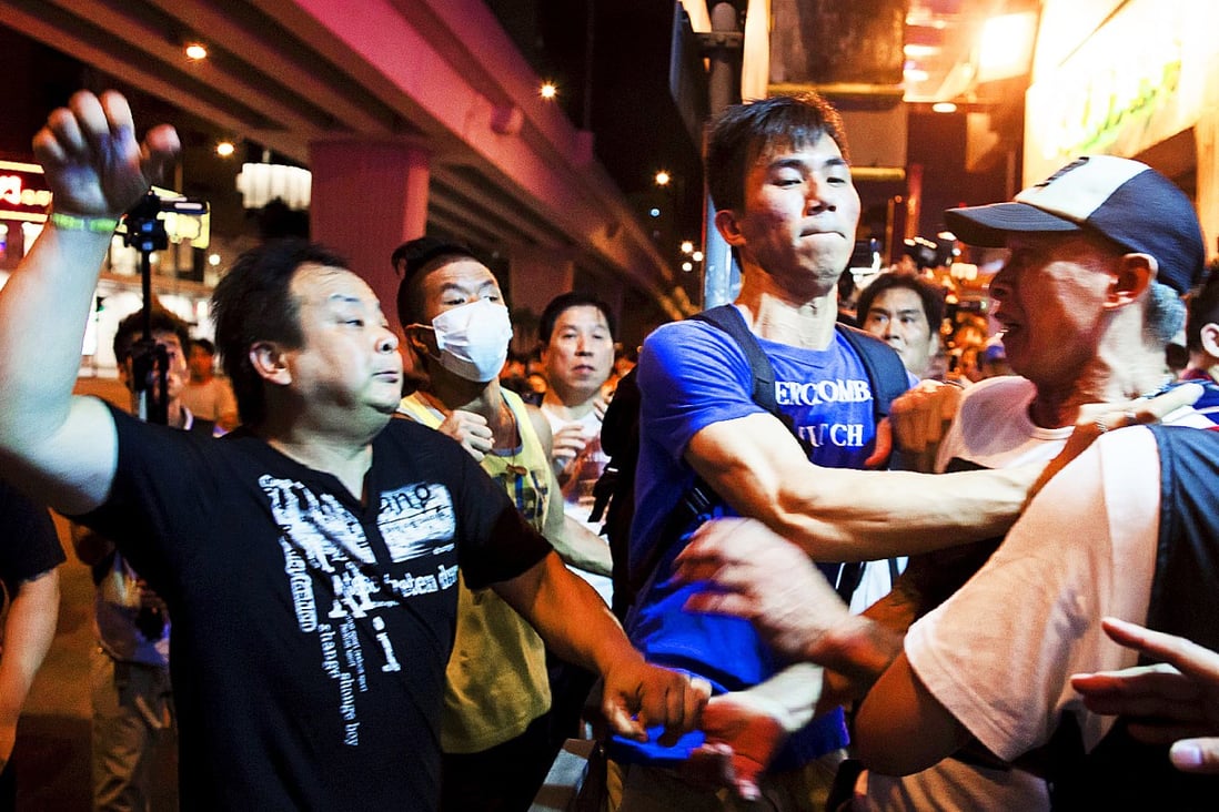 A pro-Beijing demonstrator (center) scuffles with a so-called 'localist' protester in Hong Kong's busy Mong Kok district. Photo: Reuters
